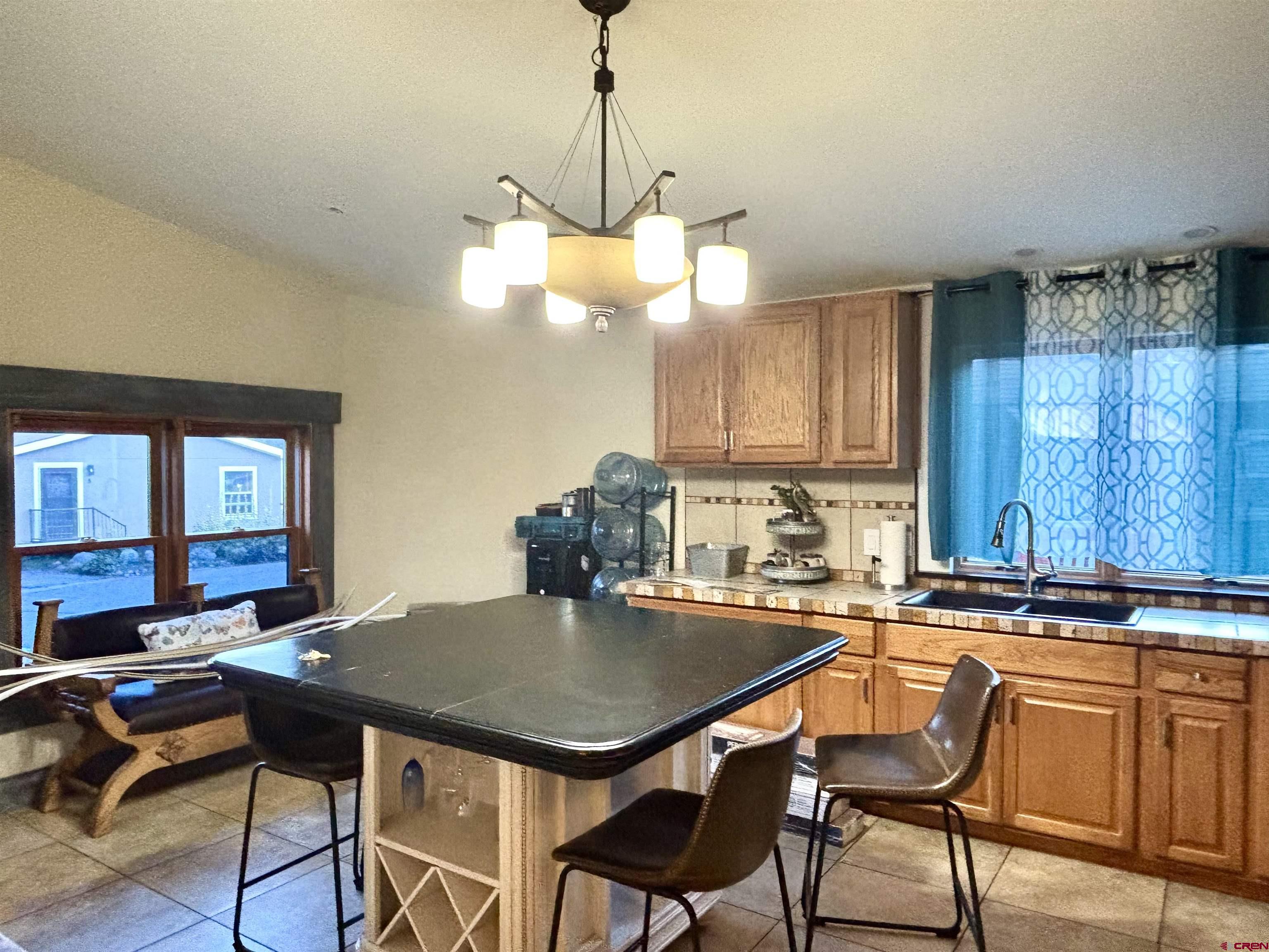 28 Raspberry Circle Durango, CO 81301 - Photo 9 of 26 a kitchen with a dining table chairs and white cabinets