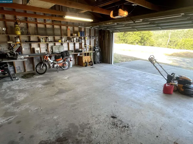 a room with a washing machine and a mirror