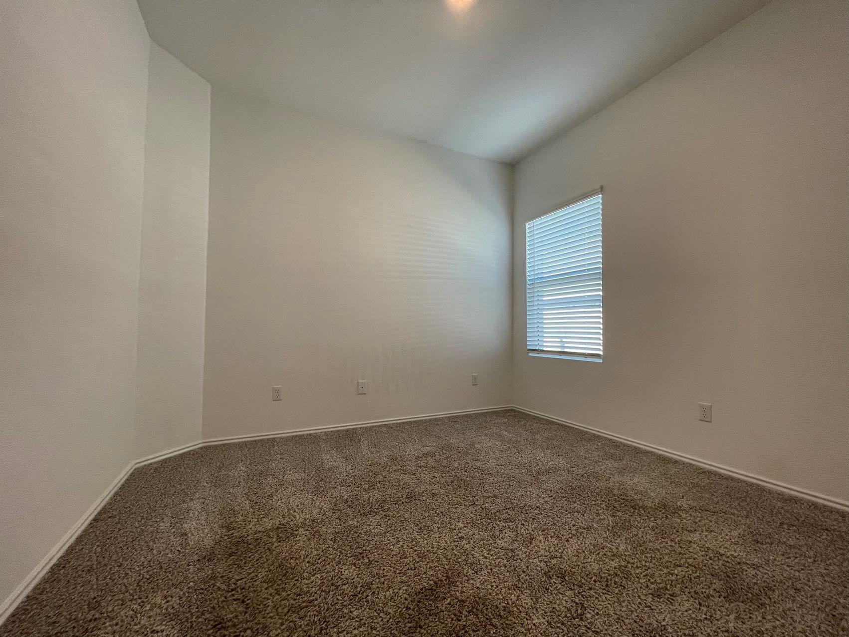 1625 Woolsey Way Leander, TX 78641 - Photo 8 of 17 This room features light-colored walls, a window with blinds, and brown carpet flooring