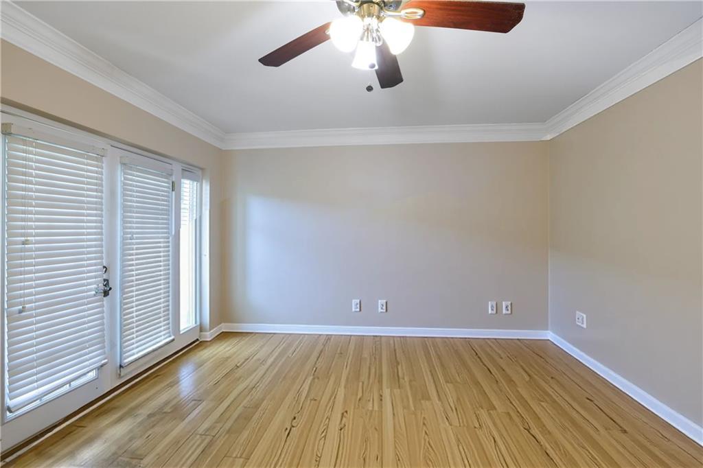 6980 Roswell Road, Unit B11 Atlanta, GA 30328 - Photo 3 of 14 an empty room with wooden floor and windows