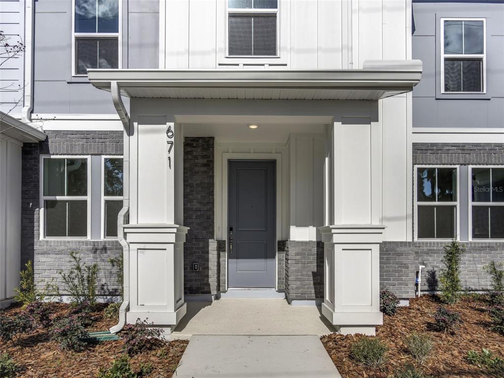671 Clark Street Oviedo, FL 32765 - Photo 3 of 24 a front view of a house with a blue gate