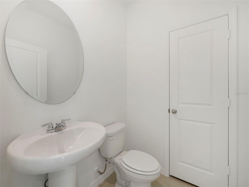 671 Clark Street Oviedo, FL 32765 - Photo 6 of 24 a bathroom with a sink a toilet and a mirror