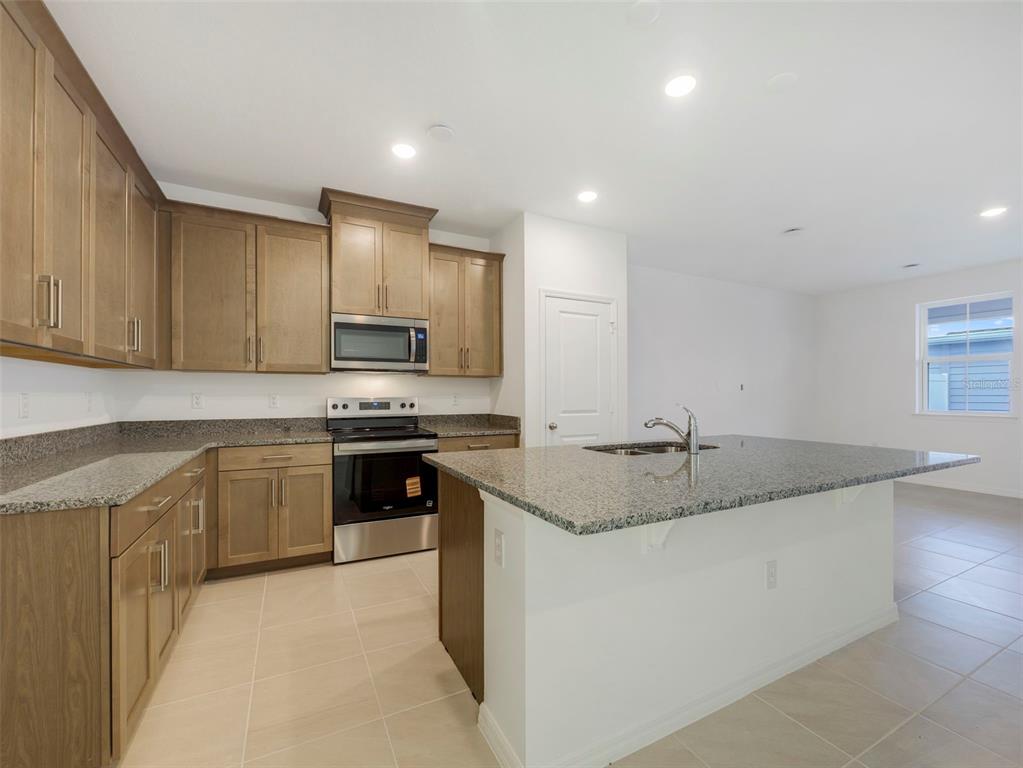 671 Clark Street Oviedo, FL 32765 - Photo 8 of 24 a kitchen with stainless steel appliances granite countertop a sink stove and cabinets