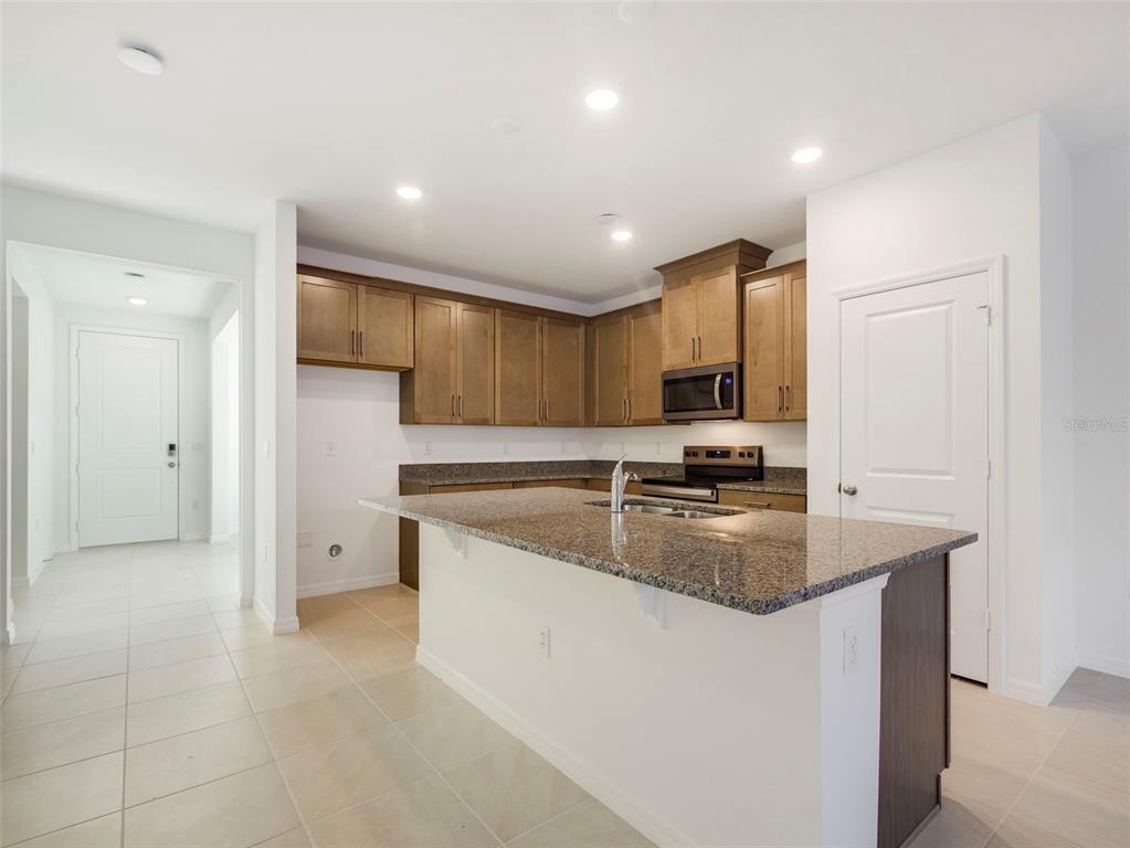 671 Clark Street Oviedo, FL 32765 - Photo 10 of 24 a kitchen with stainless steel appliances granite countertop a sink and a refrigerator