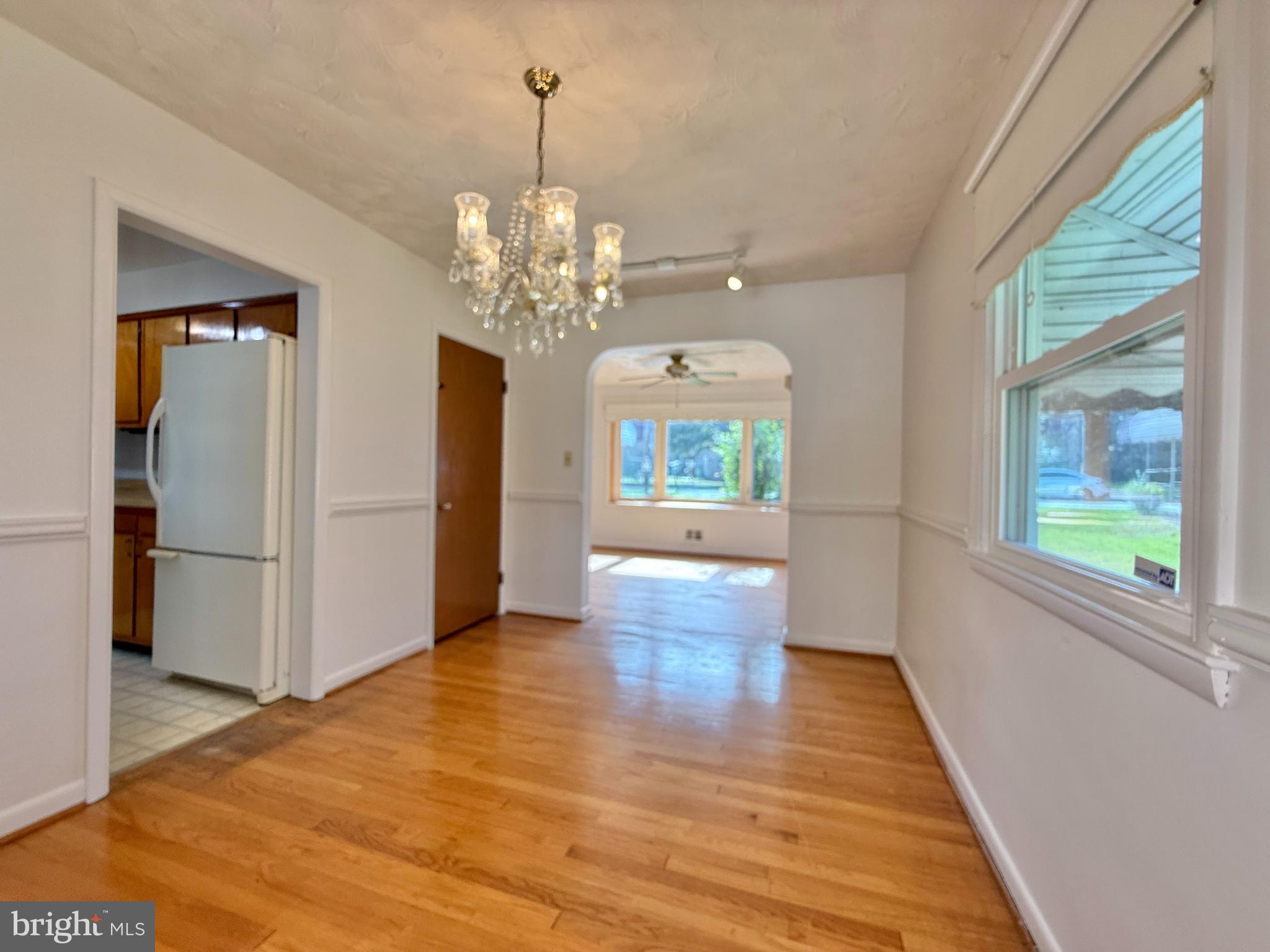 2002 Old Frederick Road Baltimore, MD 21228 - Photo 7 of 36 a view of a room with wooden floor chandelier and windows