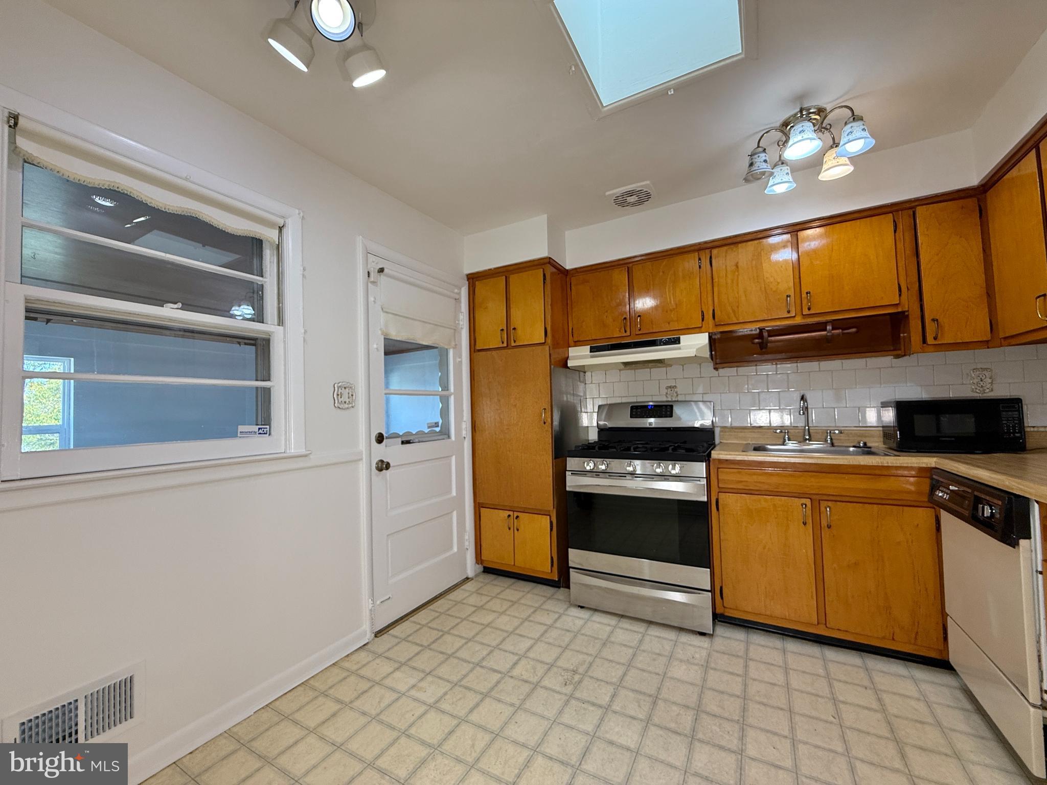 2002 Old Frederick Road Baltimore, MD 21228 - Photo 8 of 36 a kitchen with stainless steel appliances granite countertop a stove a sink and a refrigerator