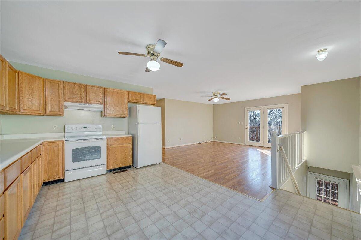 4902 Old Mountain Road Northeast Roanoke, VA 24019 - Photo 11 of 42 a kitchen with stainless steel appliances a stove top oven a sink dishwasher and a refrigerator with wooden floor
