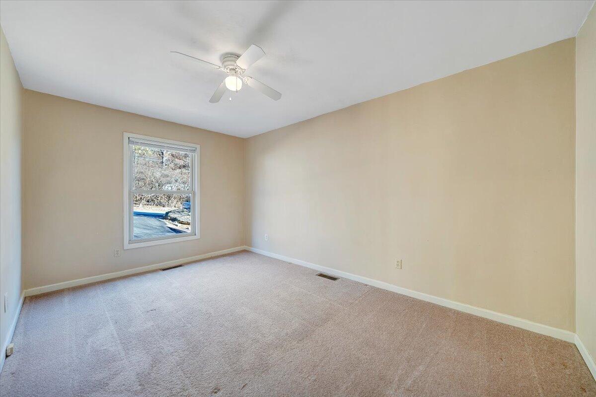 4902 Old Mountain Road Northeast Roanoke, VA 24019 - Photo 17 of 42 an empty room with windows and fan
