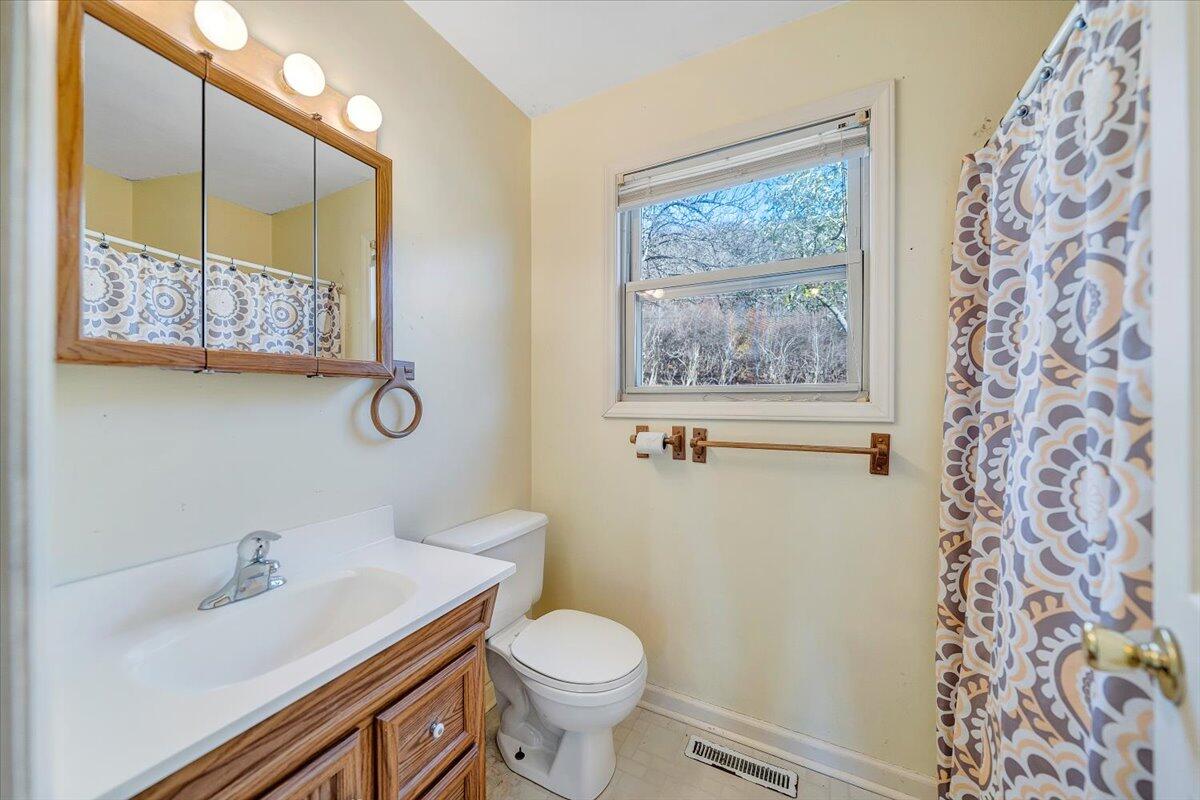 4902 Old Mountain Road Northeast Roanoke, VA 24019 - Photo 19 of 42 a white toilet sitting next to a bathroom sink