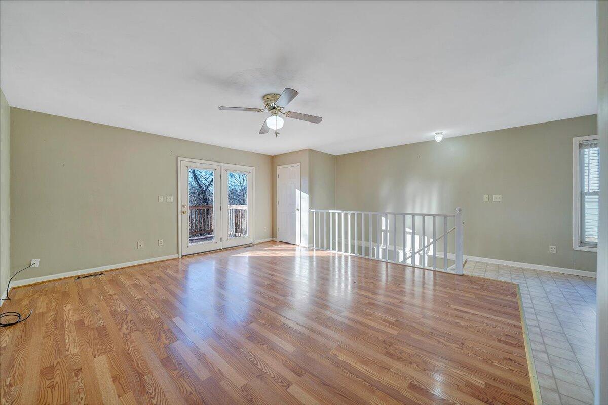 4902 Old Mountain Road Northeast Roanoke, VA 24019 - Photo 3 of 42 a view of an empty room with wooden floor and a window
