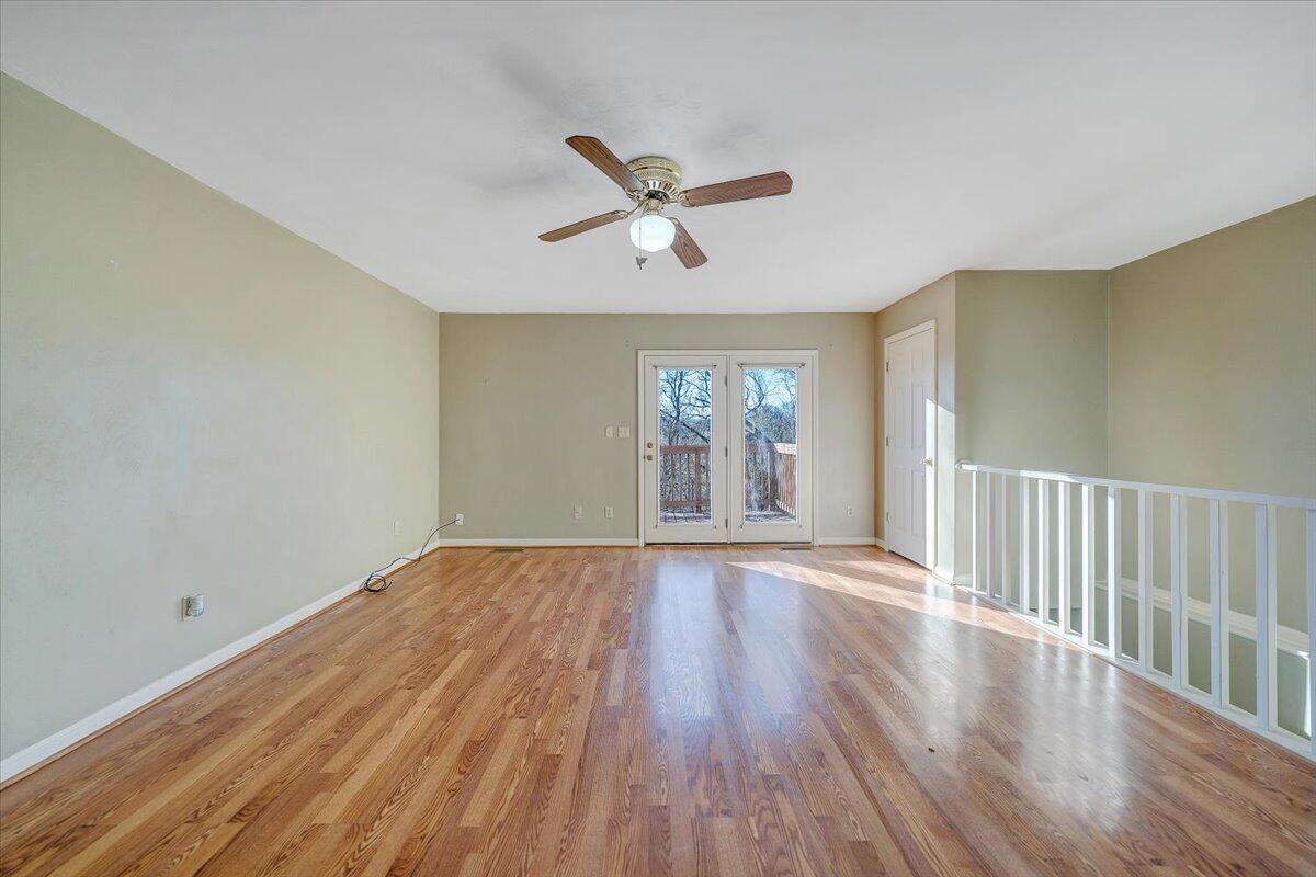 4902 Old Mountain Road Northeast Roanoke, VA 24019 - Photo 4 of 42 an empty room with wooden floor fan and windows