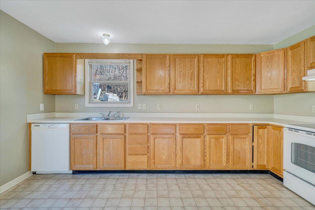 4902 Old Mountain Road Northeast Roanoke, VA 24019 - Photo 10 of 42 a kitchen with granite countertop a sink cabinets and a window