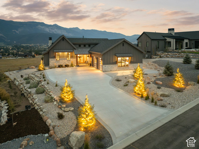 3929 Ridge Road Eden, UT 84310 - Photo 83 of 98 Exterior featuring board-and-batten siding with stone accents, a concrete driveway, and integrated outdoor lighting