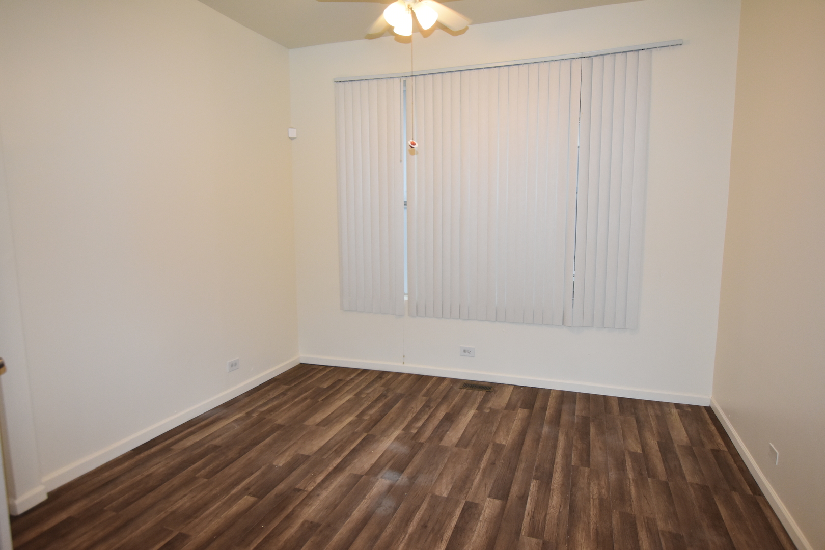 4056 West Jackson Boulevard, Unit 2 Chicago, IL 60624 - Photo 12 of 14 a view of small space with wooden floor and fan