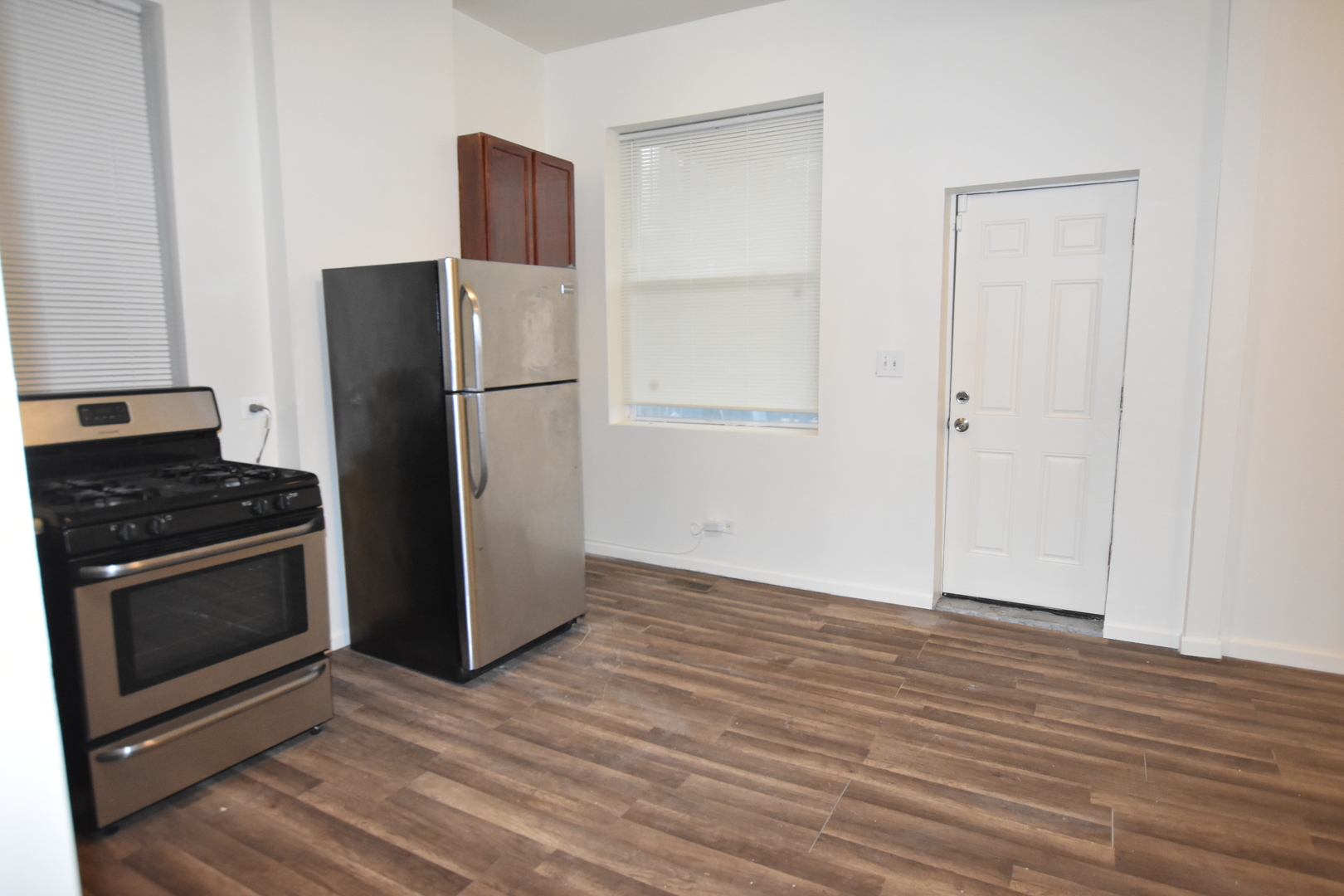 4056 West Jackson Boulevard, Unit 2 Chicago, IL 60624 - Photo 13 of 14 a kitchen with a refrigerator cabinet and a sink