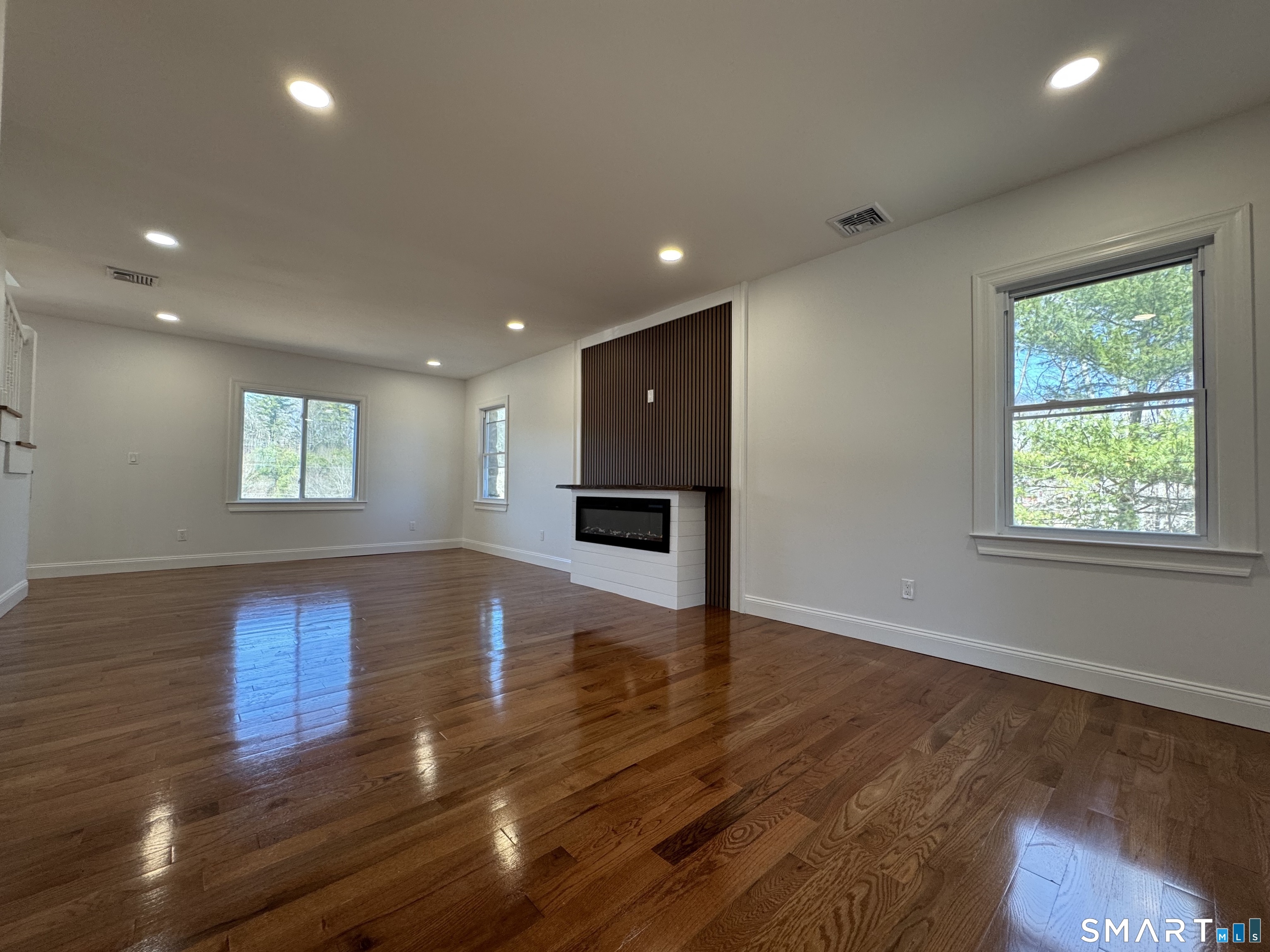 243 Long Hill Road Andover, CT 06232 - Photo 4 of 31 a view of empty room with wooden floor and window