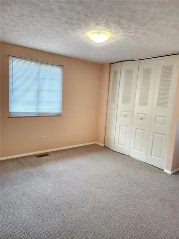 a view of an empty room and a window