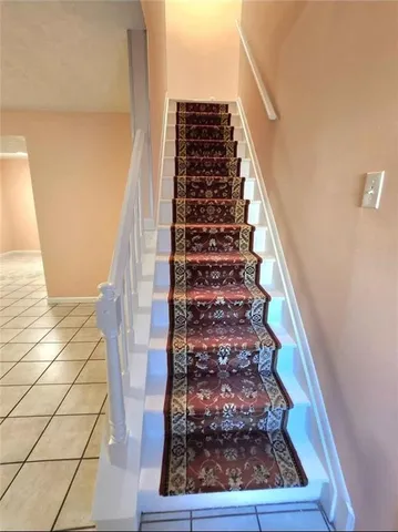 a view of staircase with wooden floor and windows