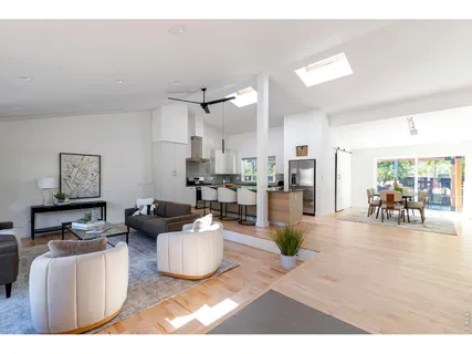 a living room with furniture and a view of kitchen