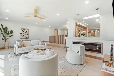 a living room with furniture and a potted plant