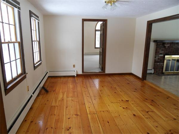 63 Purgatory Road Sutton, MA 01590 - Photo 8 of 22 an empty room with wooden floor and windows