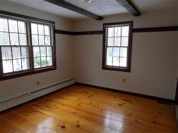 63 Purgatory Road Sutton, MA 01590 - Photo 9 of 22 an empty room with wooden floor and windows