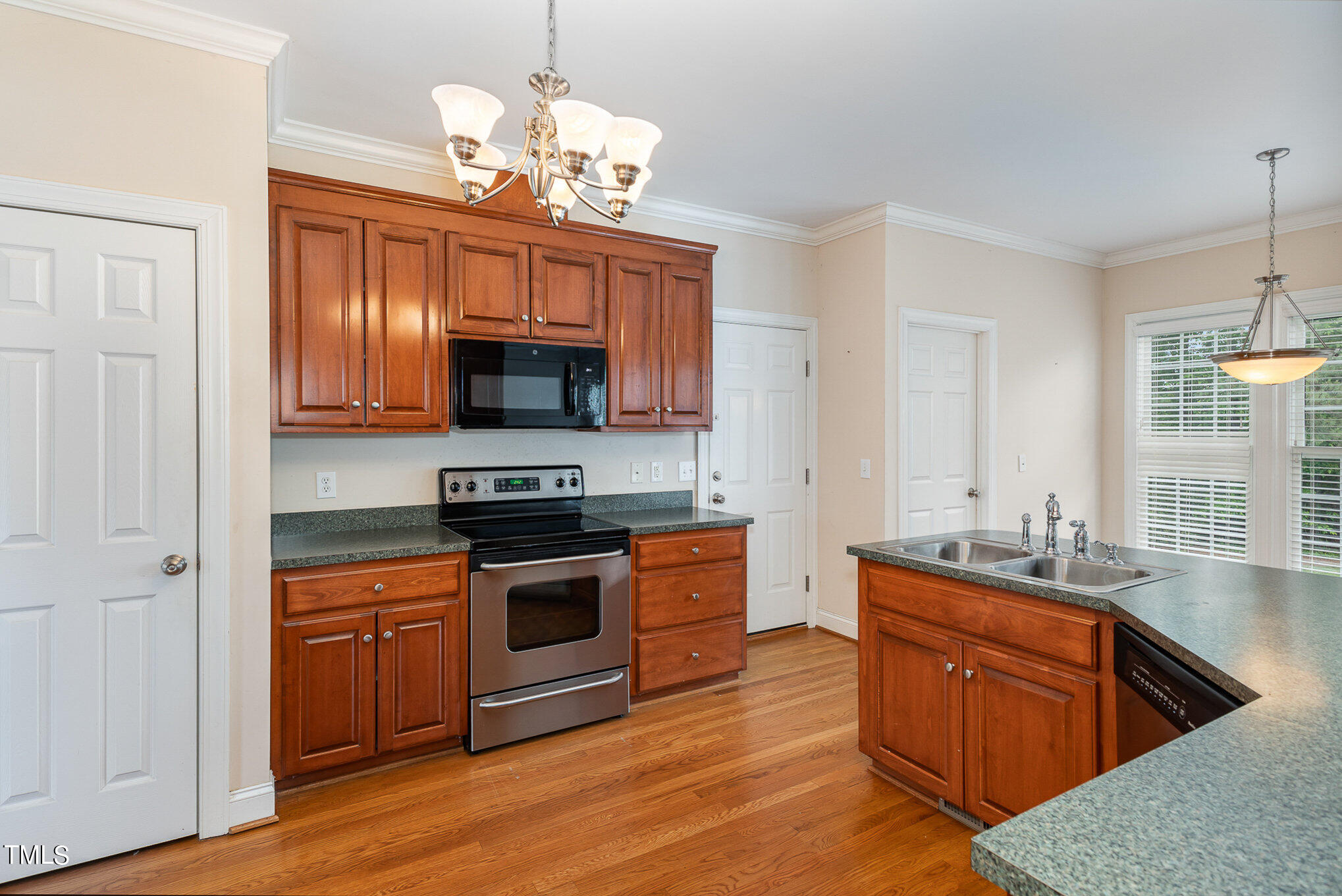 2809 Oak Bridge Drive Raleigh, NC 27610 - Photo 14 of 37 a kitchen with stainless steel appliances granite countertop a stove a sink and a microwave