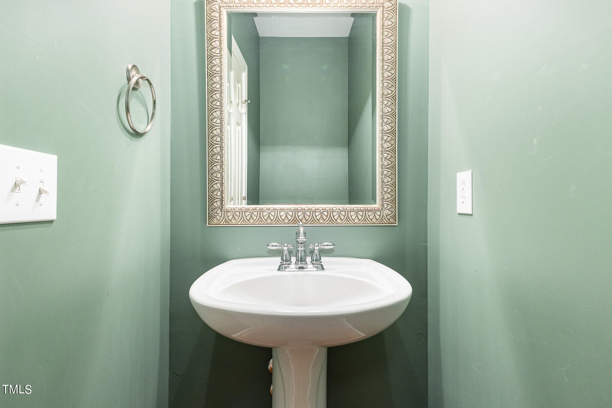 2809 Oak Bridge Drive Raleigh, NC 27610 - Photo 15 of 37 a bathroom with a sink and a mirror