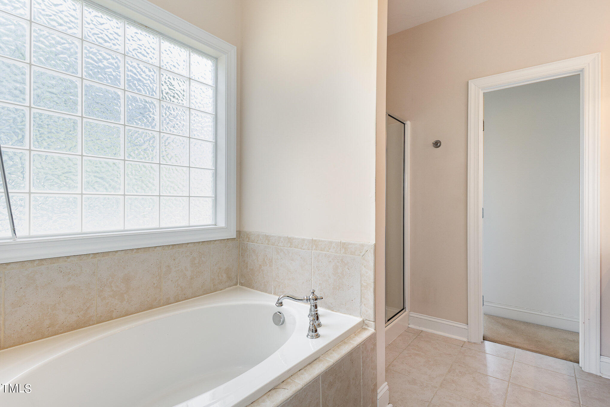 2809 Oak Bridge Drive Raleigh, NC 27610 - Photo 18 of 37 a white bath tub sitting next to a window