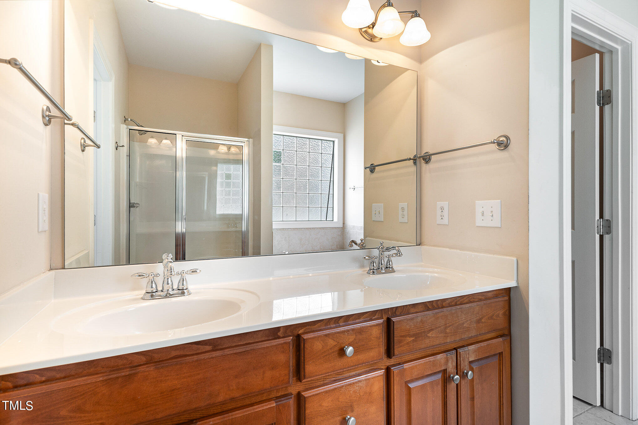2809 Oak Bridge Drive Raleigh, NC 27610 - Photo 19 of 37 a bathroom with a sink double vanity and a mirror