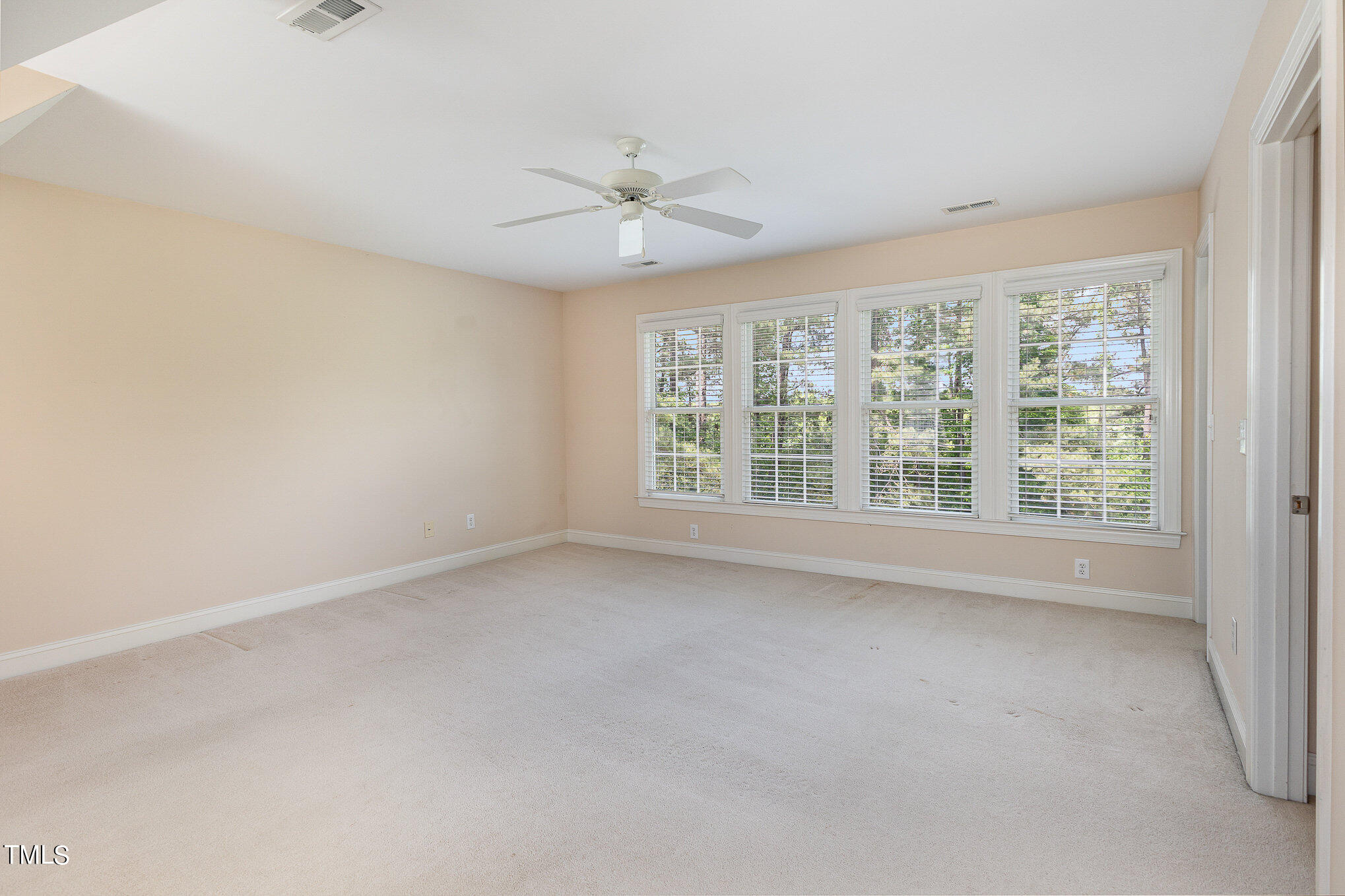 2809 Oak Bridge Drive Raleigh, NC 27610 - Photo 20 of 37 an empty room with a window and a fan