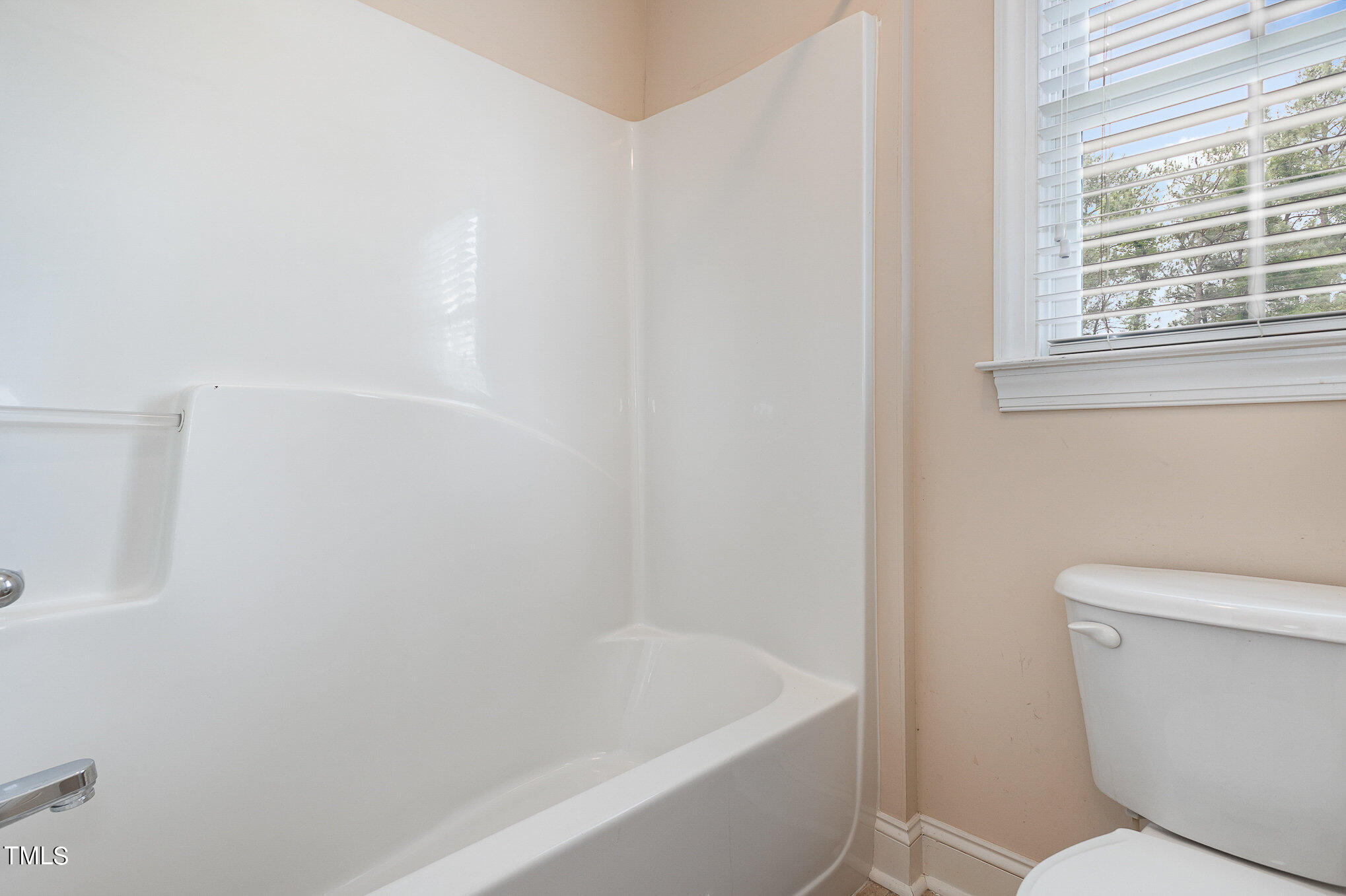 2809 Oak Bridge Drive Raleigh, NC 27610 - Photo 29 of 37 a white toilet sitting next to a bath tub