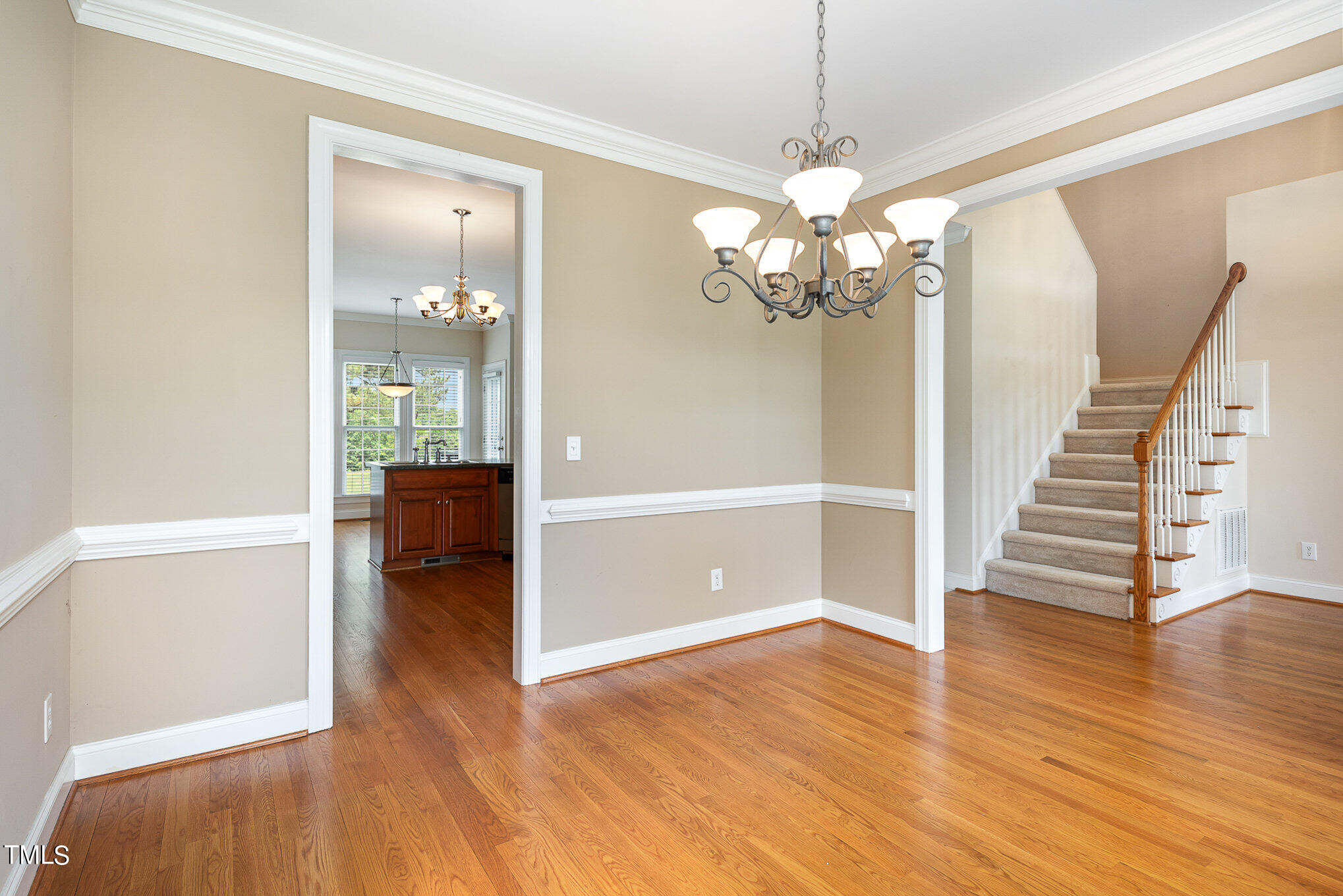 2809 Oak Bridge Drive Raleigh, NC 27610 - Photo 7 of 37 a view of a livingroom with wooden floor and a chandelier