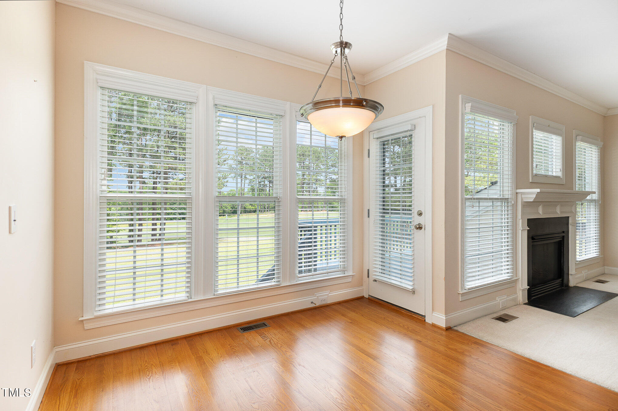 2809 Oak Bridge Drive Raleigh, NC 27610 - Photo 9 of 37 a view of a room with wooden floor fireplace and windows