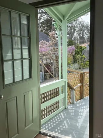 a view of a small space with wooden floor and a window