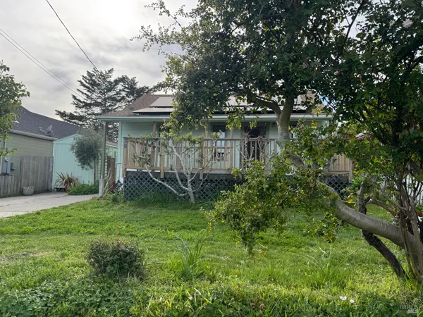 a view of a street with wooden fence