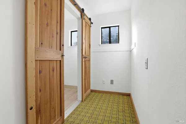 a view of a hallway with washer and dryer