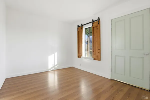 a view of a kitchen with wooden floor and a kitchen