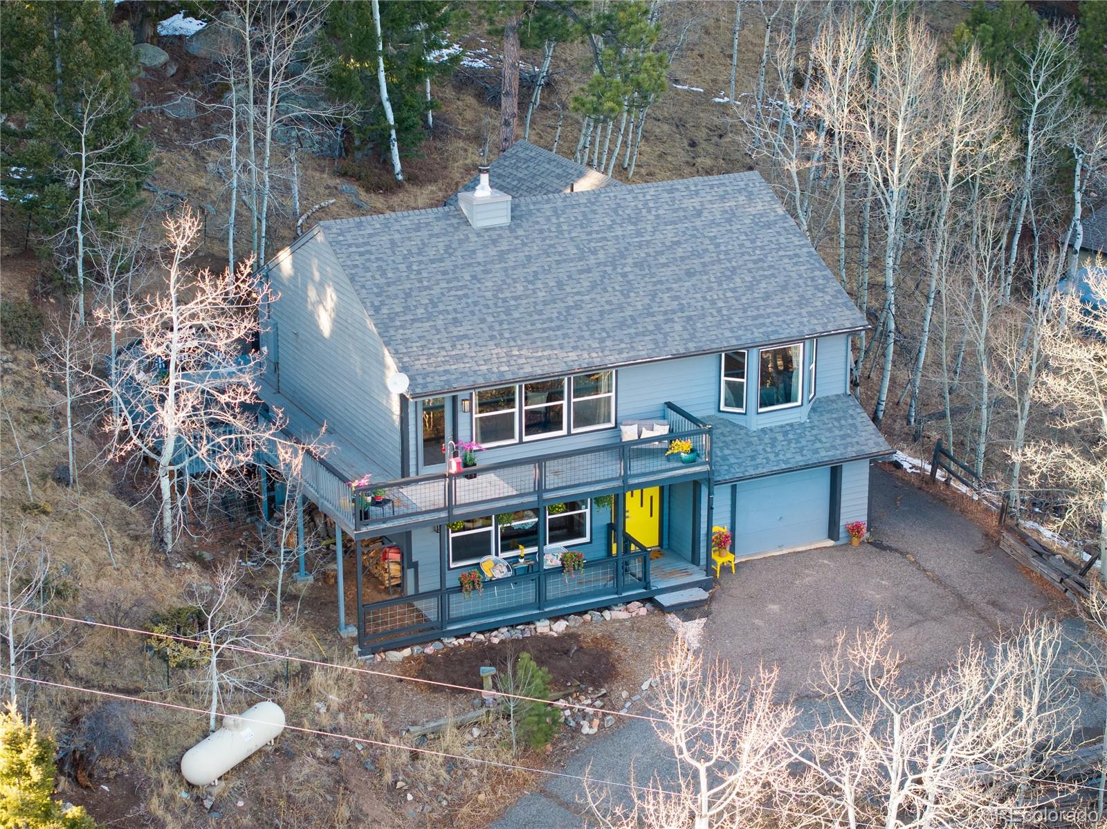 11740 Baca Road Conifer, CO 80433 - Photo 49 of 49 a front view of a house with garden