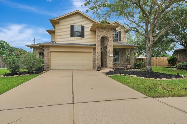 a front view of a house with a yard and garage