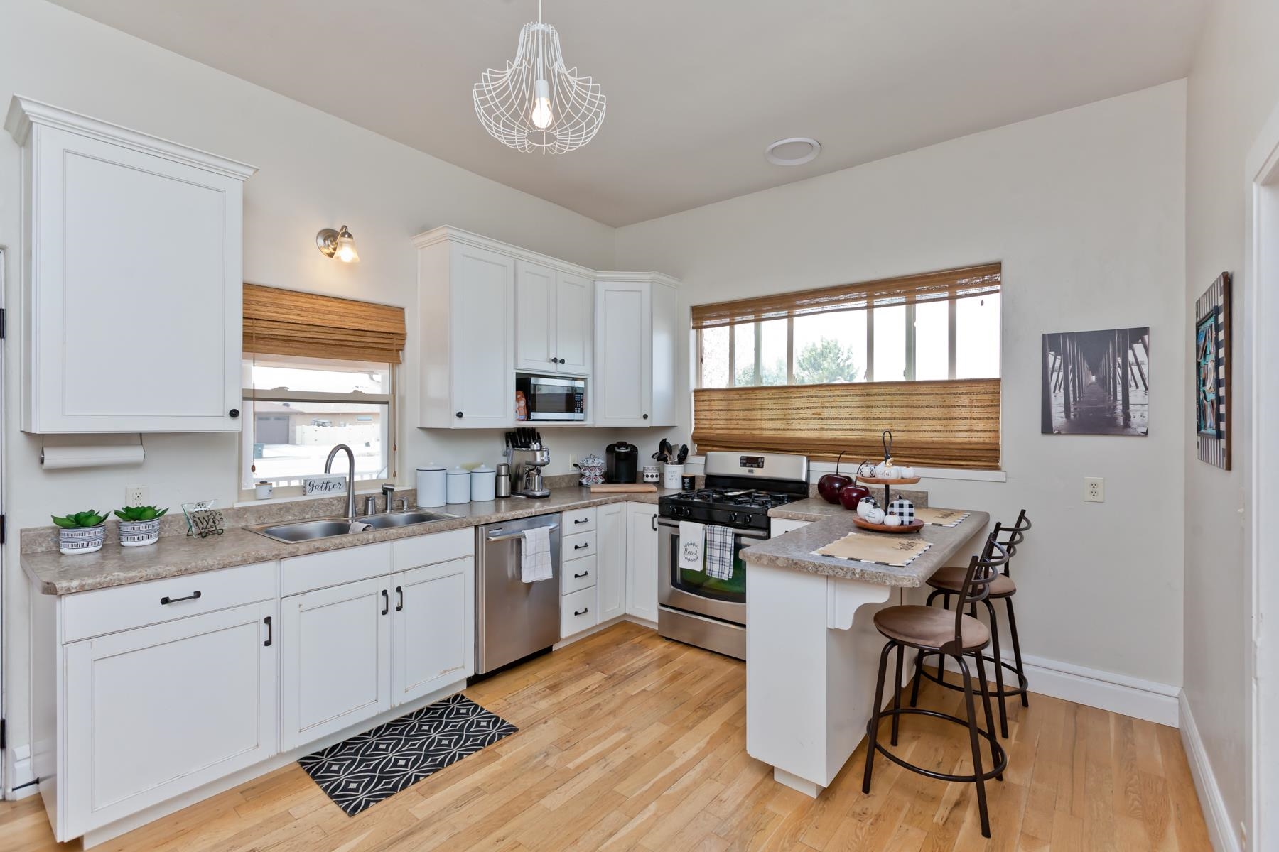 225 29 Road Grand Junction, CO 81503 - Photo 20 of 41 a kitchen with a sink stove cabinets and wooden floor