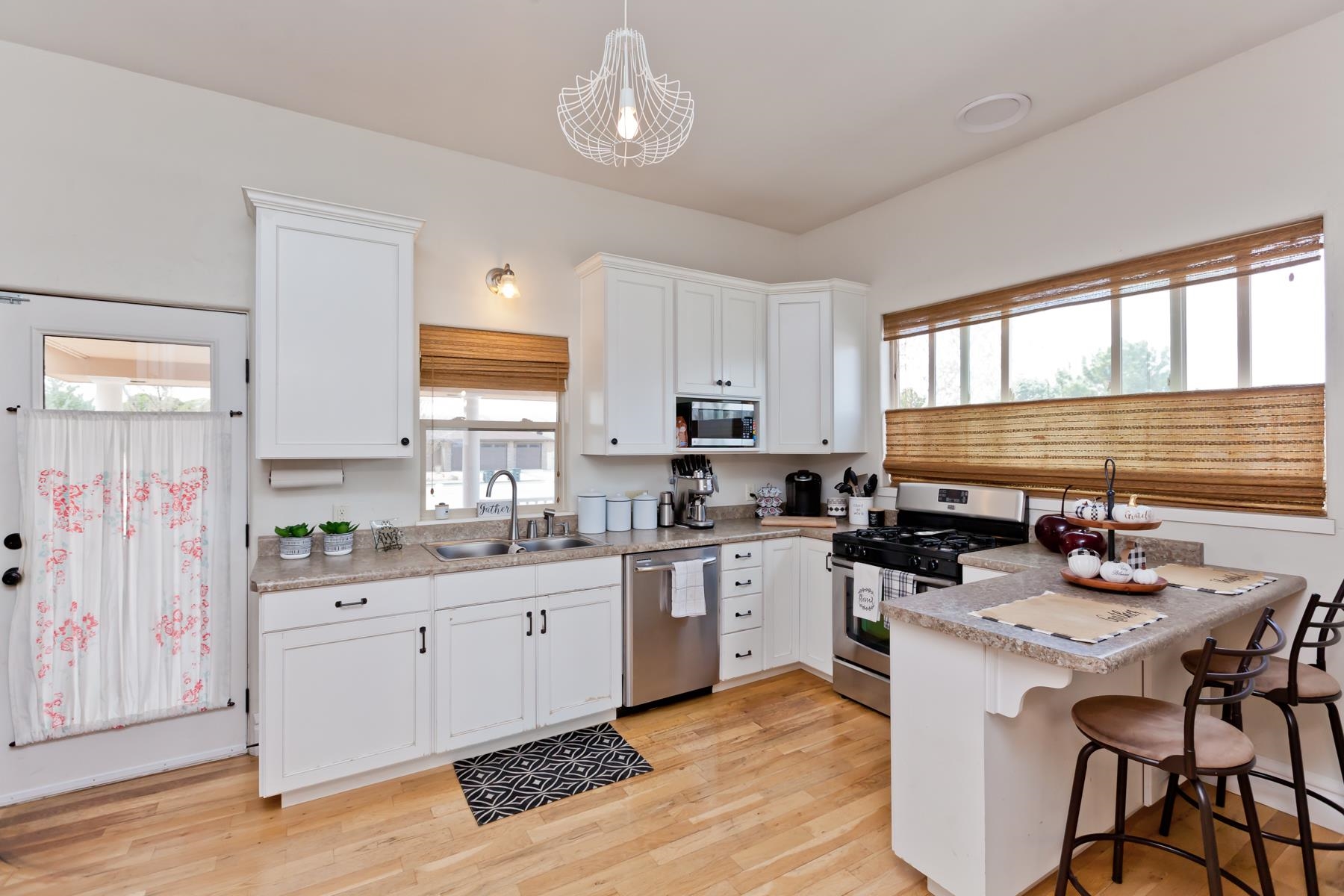 225 29 Road Grand Junction, CO 81503 - Photo 23 of 41 a kitchen with granite countertop a sink appliances cabinets and wooden floor