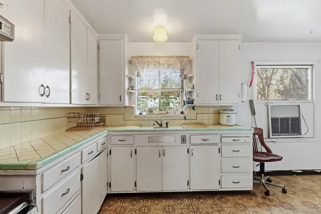 a refrigerator freezer sitting inside of a kitchen