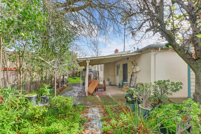 an aerial view of residential houses with outdoor space and trees