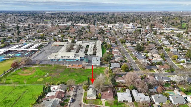 an aerial view of a house with a yard and swimming pool