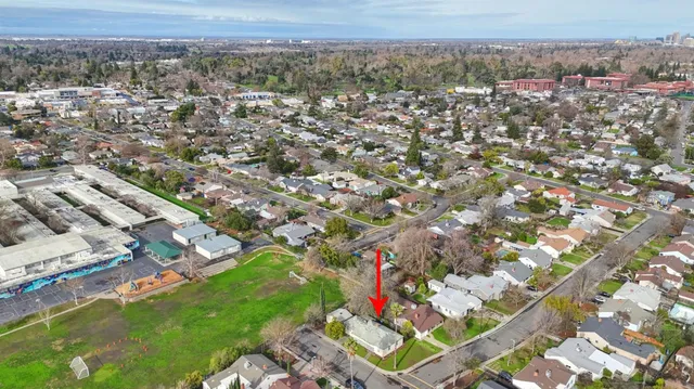 an aerial view of residential houses with outdoor space and swimming pool