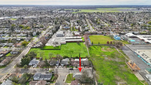 an aerial view of residential building and car parked