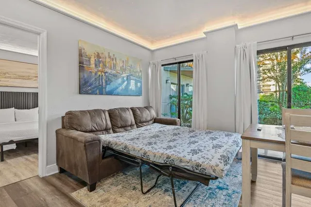 a bedroom with a bed and a painting on the wall