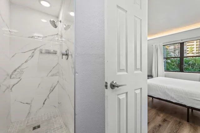 a bedroom with a bed and chandelier