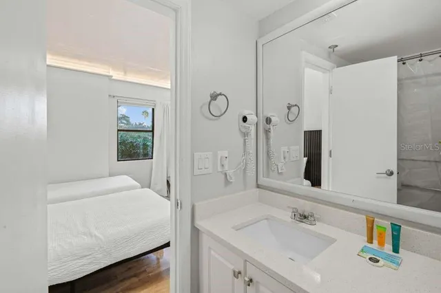 a large bed sitting in a bedroom next to a window